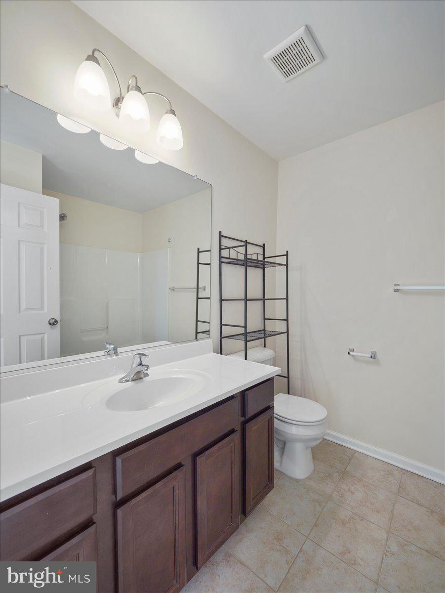35 Montague Way Inwood, WV 25428 - Photo 36 of 38 a bathroom with a sink a toilet and mirror