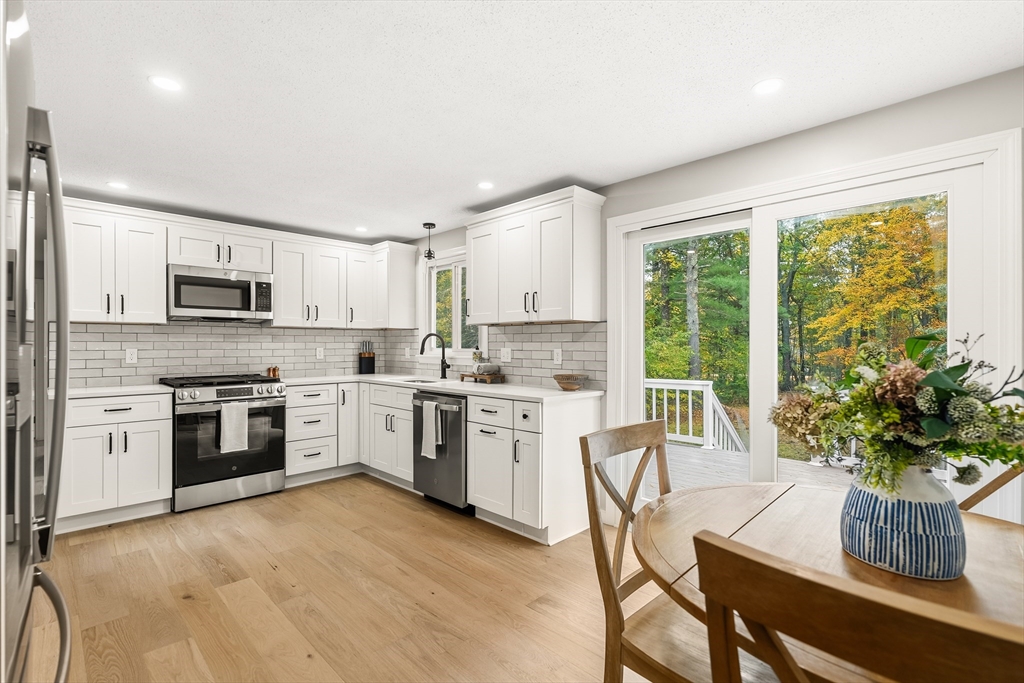 293 Mendall Road Acushnet, MA 02743 - Photo 11 of 41 a kitchen with a stove a sink and a refrigerator