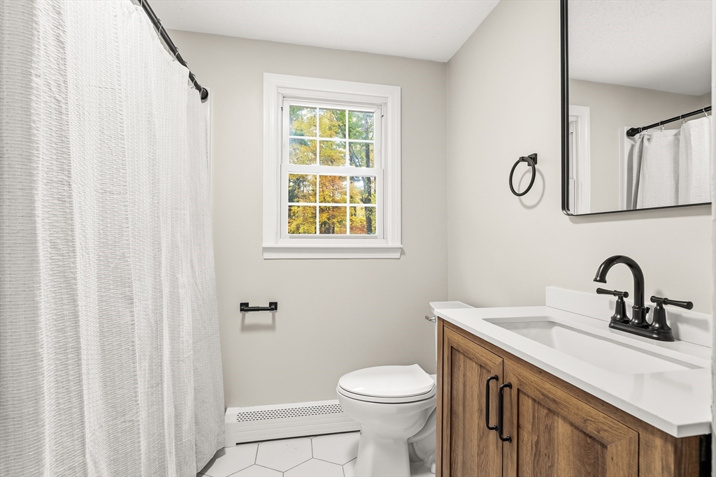 293 Mendall Road Acushnet, MA 02743 - Photo 25 of 41 a bathroom with a sink a toilet and a mirror