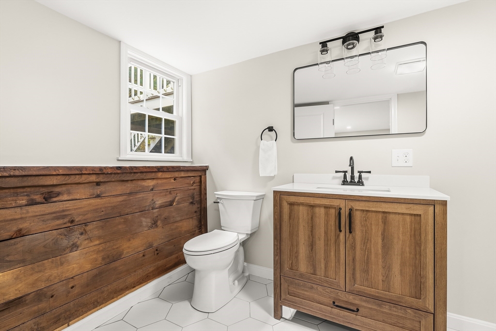 293 Mendall Road Acushnet, MA 02743 - Photo 33 of 41 a bathroom with a toilet sink and mirror