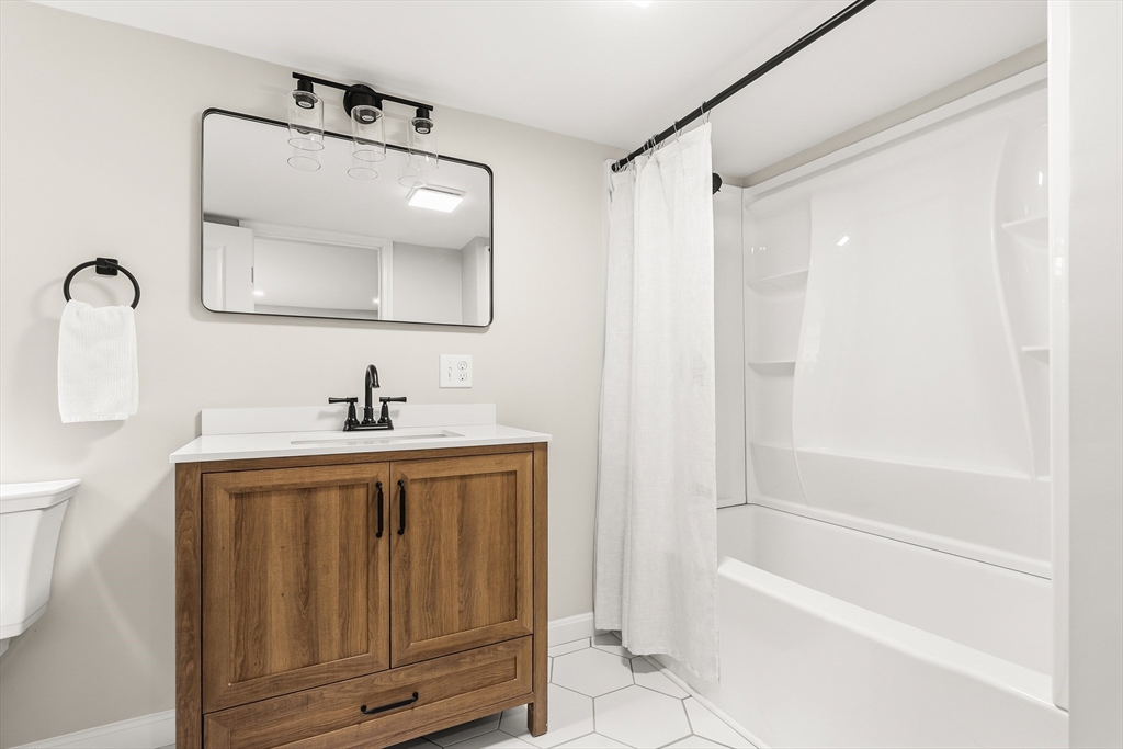 293 Mendall Road Acushnet, MA 02743 - Photo 34 of 41 a bathroom with a bathtub shower sink vanity and mirror