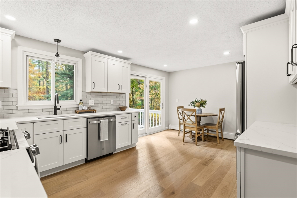 293 Mendall Road Acushnet, MA 02743 - Photo 9 of 41 a kitchen with sink cabinets and wooden floor