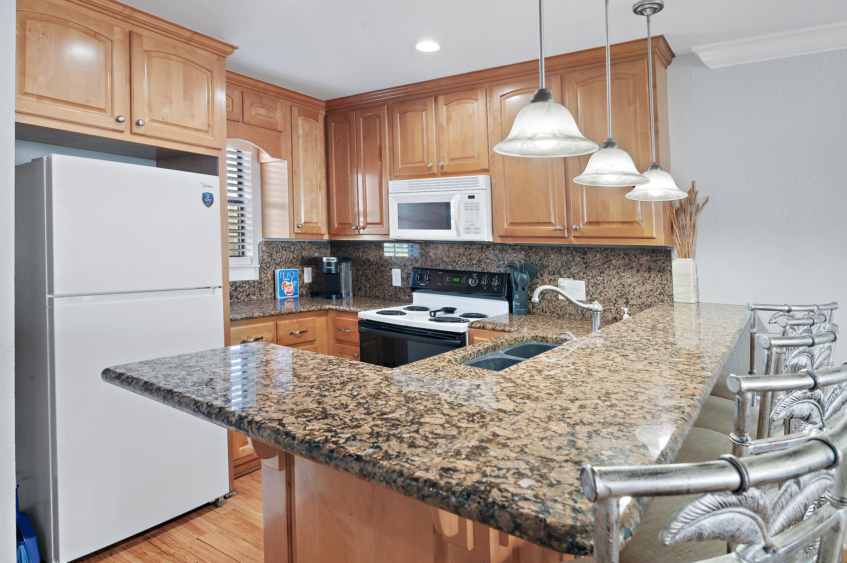3680 East County Highway 30A, Unit 4 Santa Rosa Beach, FL 32459 - Photo 7 of 17 a kitchen with stainless steel appliances granite countertop a sink a stove and a refrigerator