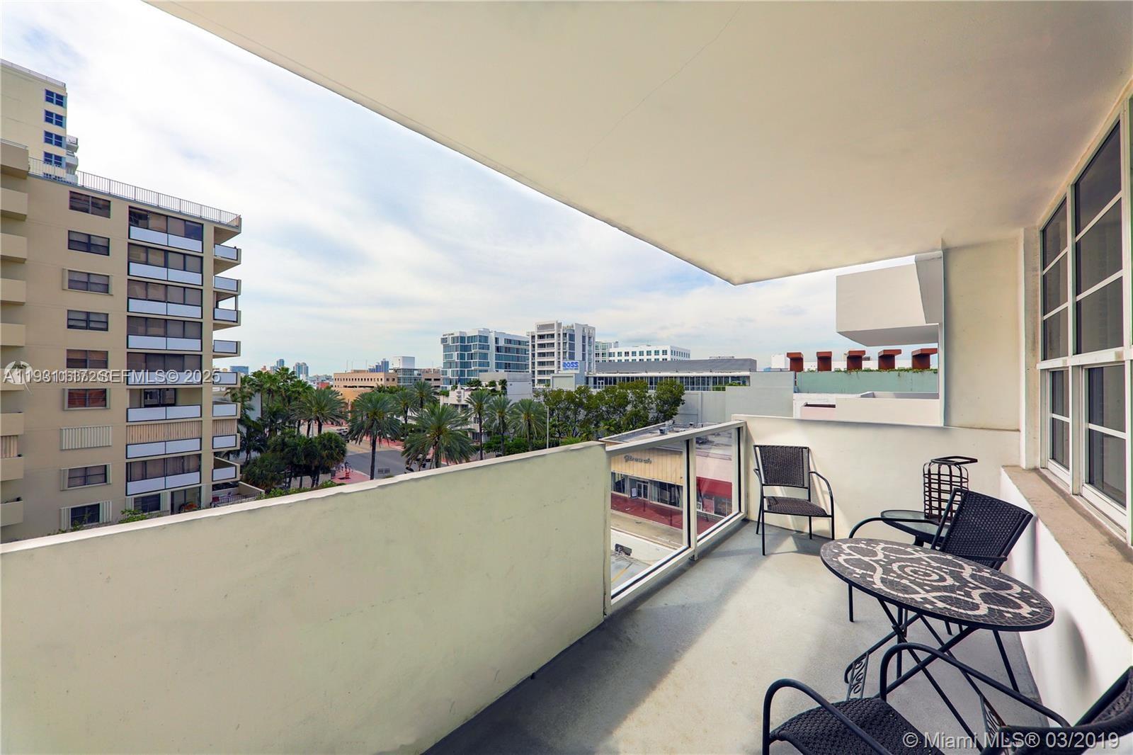 100 Lincoln Road, Unit 509 Miami Beach, FL 33139 - Photo 11 of 20 a balcony with table and chairs