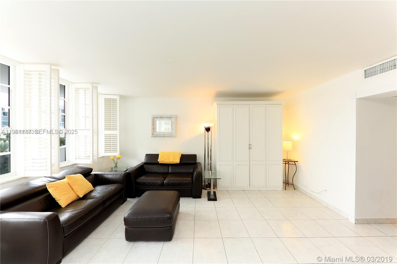 100 Lincoln Road, Unit 509 Miami Beach, FL 33139 - Photo 2 of 20 a living room with furniture and a large window