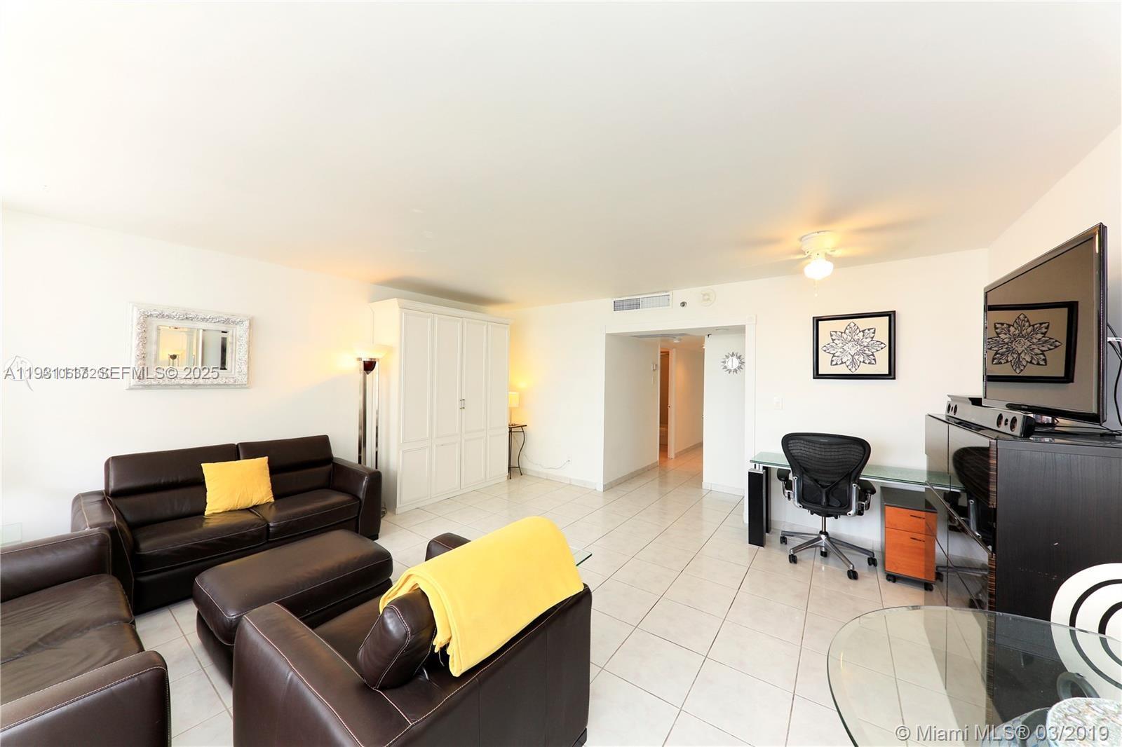 100 Lincoln Road, Unit 509 Miami Beach, FL 33139 - Photo 4 of 20 a living room with furniture and a flat screen tv