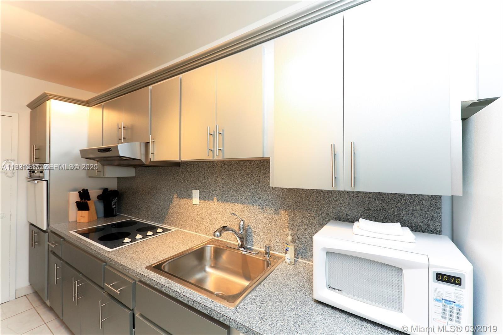 100 Lincoln Road, Unit 509 Miami Beach, FL 33139 - Photo 6 of 20 a kitchen with a sink a stove and cabinets