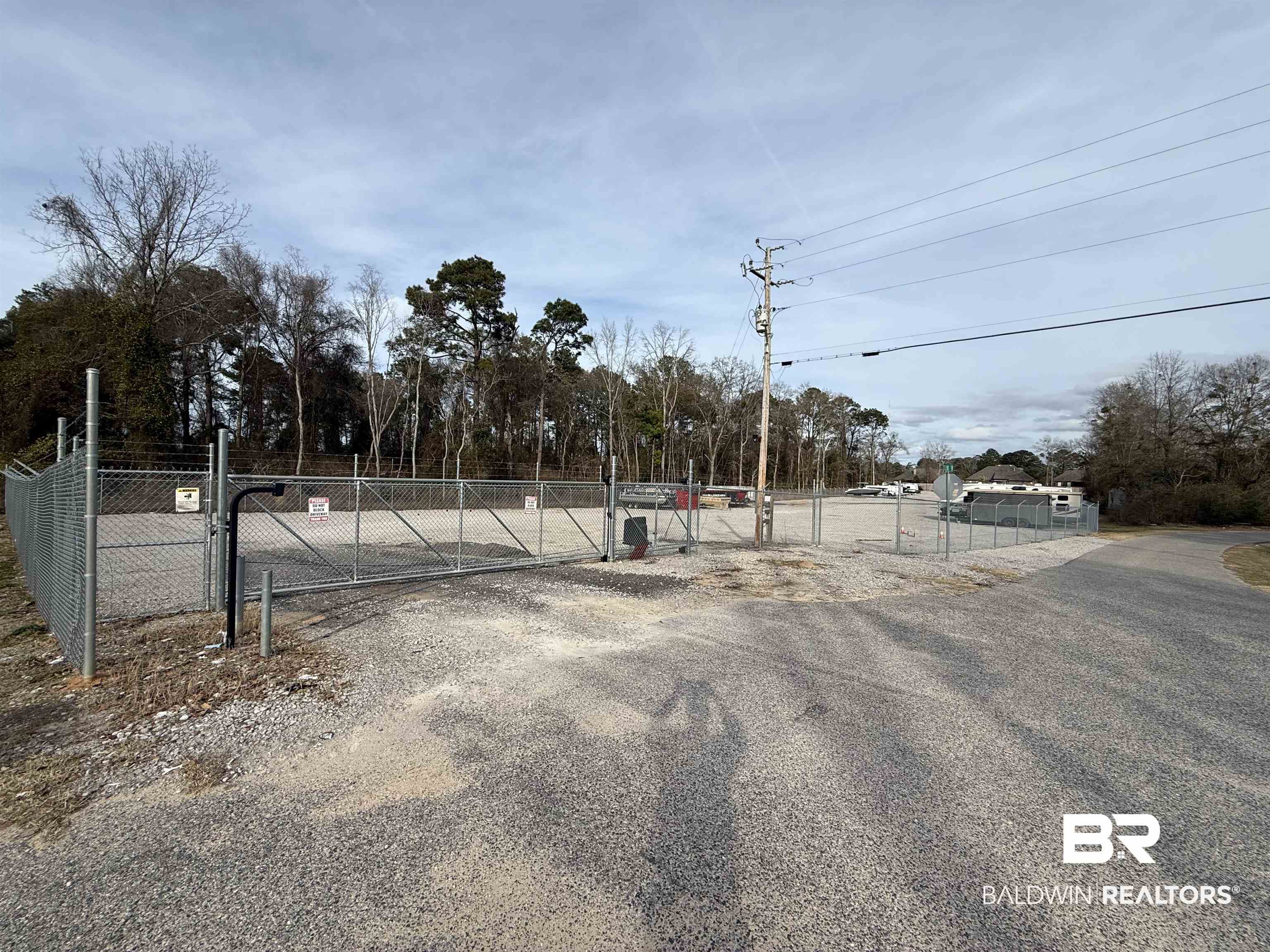 31420 Jessie Road Daphne, AL 36527 - Photo 14 of 23 View of asphalt road with a gate