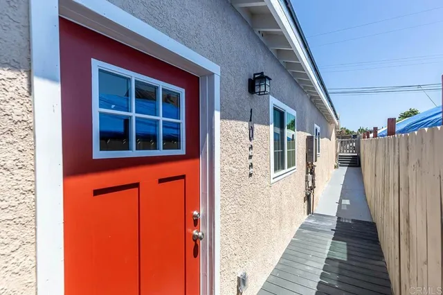 a view of a brick house with wooden stairs