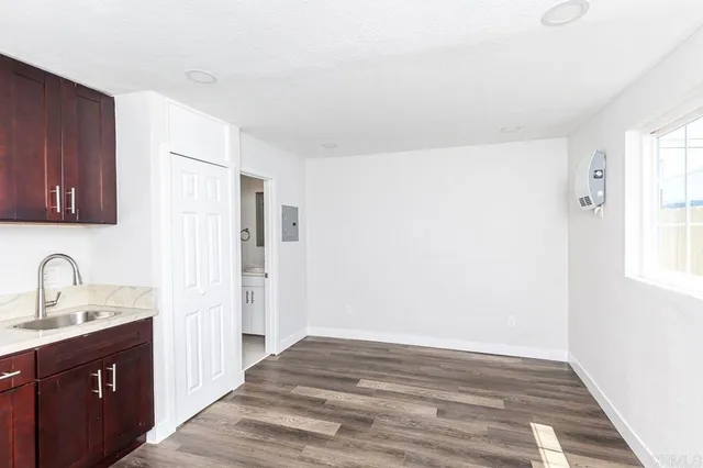 a view of a kitchen with a sink and cabinets