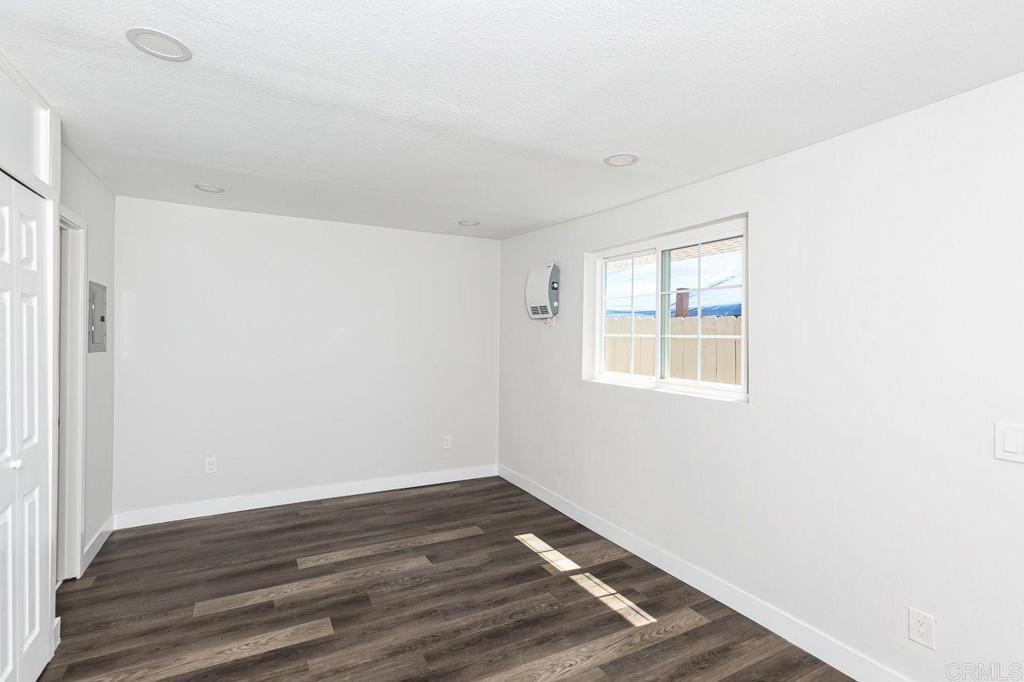 1020 41st Street San Diego, CA 92102 - Photo 20 of 39 a view of an empty room with wooden floor and a window