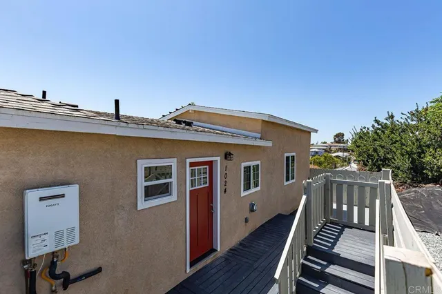 a front view of house with deck and yard