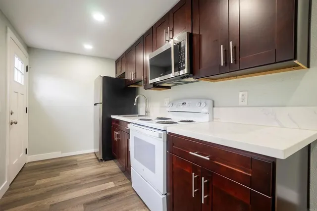 a kitchen with stainless steel appliances a stove microwave and refrigerator