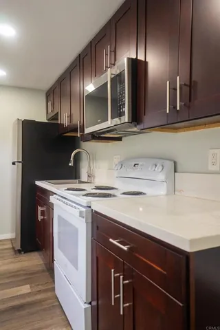 a kitchen with a sink and a refrigerator