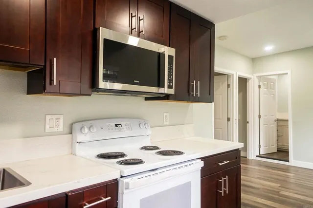 a kitchen with a sink a stove and cabinets