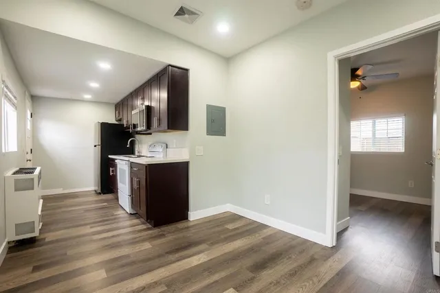 a view of kitchen with cabinets and wooden floor