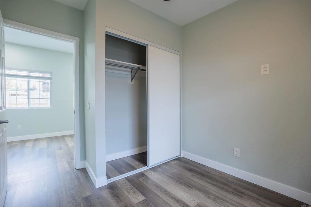 1020 41st Street San Diego, CA 92102 - Photo 36 of 39 an empty room with wooden floor closet and windows