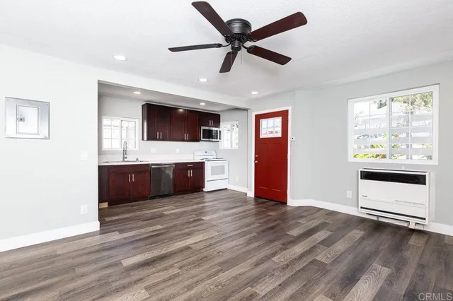 a bedroom with furniture and a flat screen tv