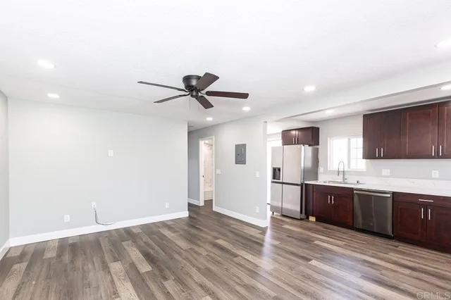 a view of kitchen with sink and wooden floor