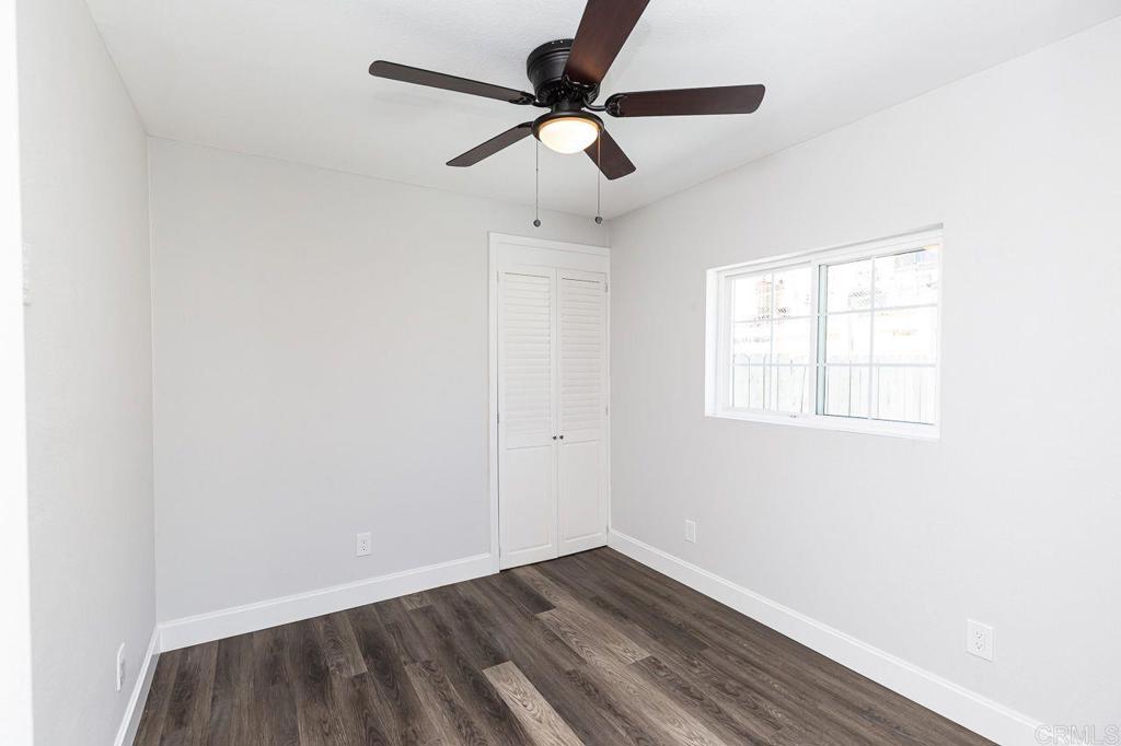 1020 41st Street San Diego, CA 92102 - Photo 9 of 39 an empty room with wooden floor ceiling fan and window