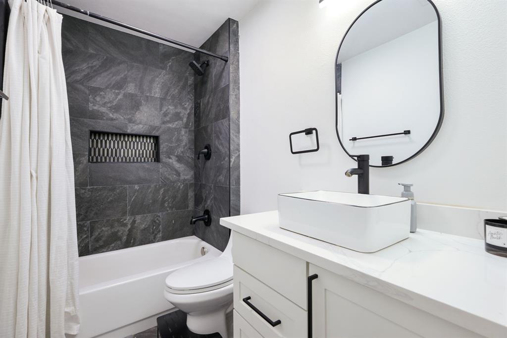 1831 Wintergreen Road Carrollton, TX 75006 - Photo 19 of 28 a bathroom with a sink a toilet and shower