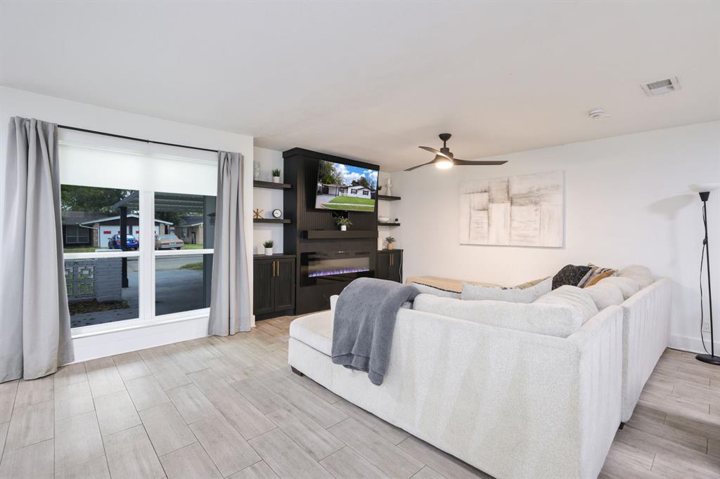 1831 Wintergreen Road Carrollton, TX 75006 - Photo 3 of 28 a living room with furniture and a wooden floor