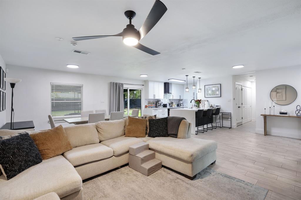 1831 Wintergreen Road Carrollton, TX 75006 - Photo 10 of 28 a living room with furniture kitchen view and a wooden floor