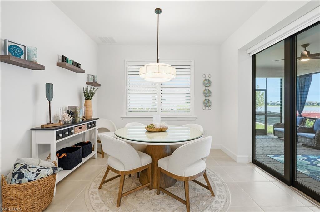 18364 Ridgeline Drive Estero, FL 33928 - Photo 17 of 50 a view of a dining room with furniture and front door