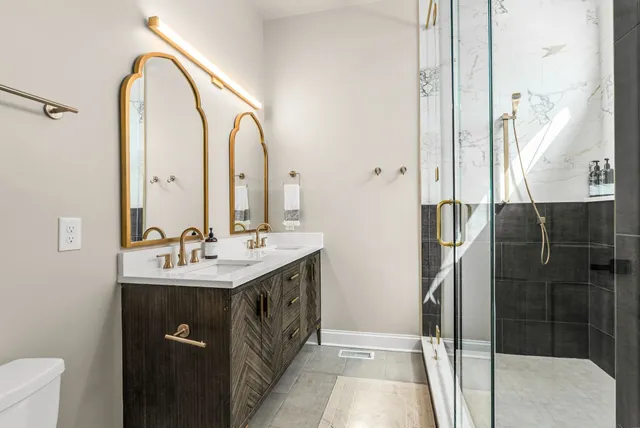 a bathroom with a mirror a bathtub and a shower