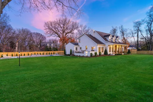 a front view of house with backyard and garden
