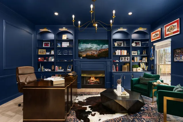 a living room with furniture a bookshelf and a fireplace