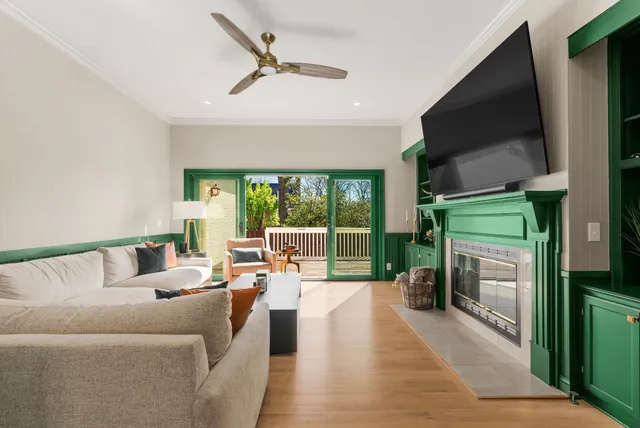 a living room with fireplace furniture and a flat screen tv