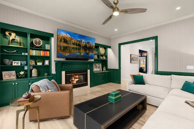 a living room with furniture a fireplace and a flat screen tv