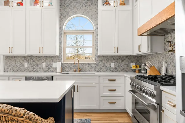 a kitchen with cabinets appliances and a window