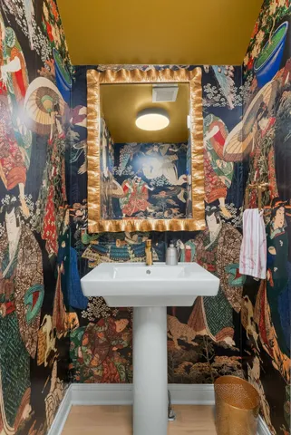 a spacious bedroom with a large bed and a chandelier