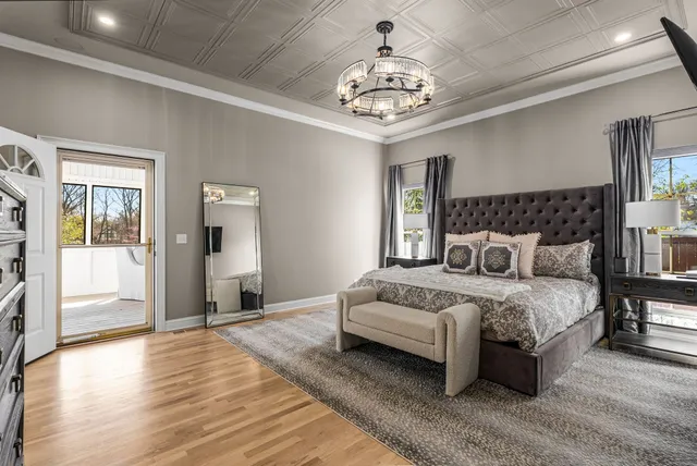 a bedroom with a bed and a chandelier