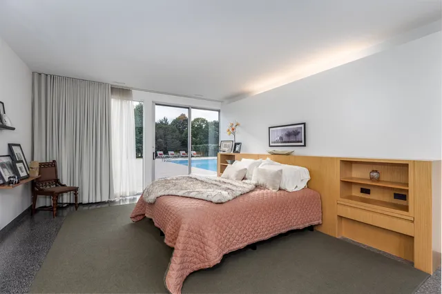 a large white kitchen with a large window