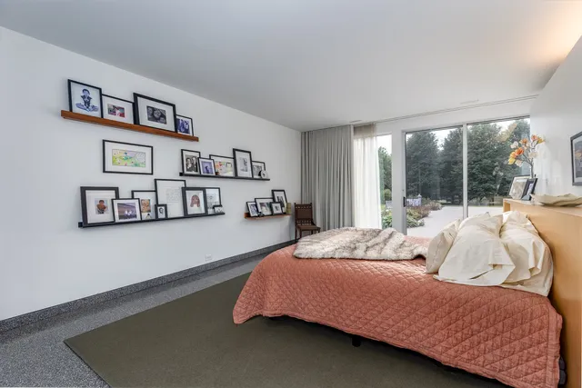 a view of a hallway with wooden floor and furniture