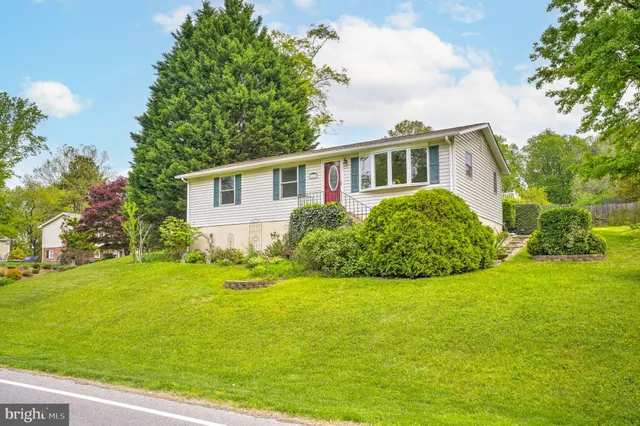 a view of a house with garden and trees