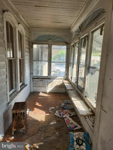 a view of a bedroom with wooden floor