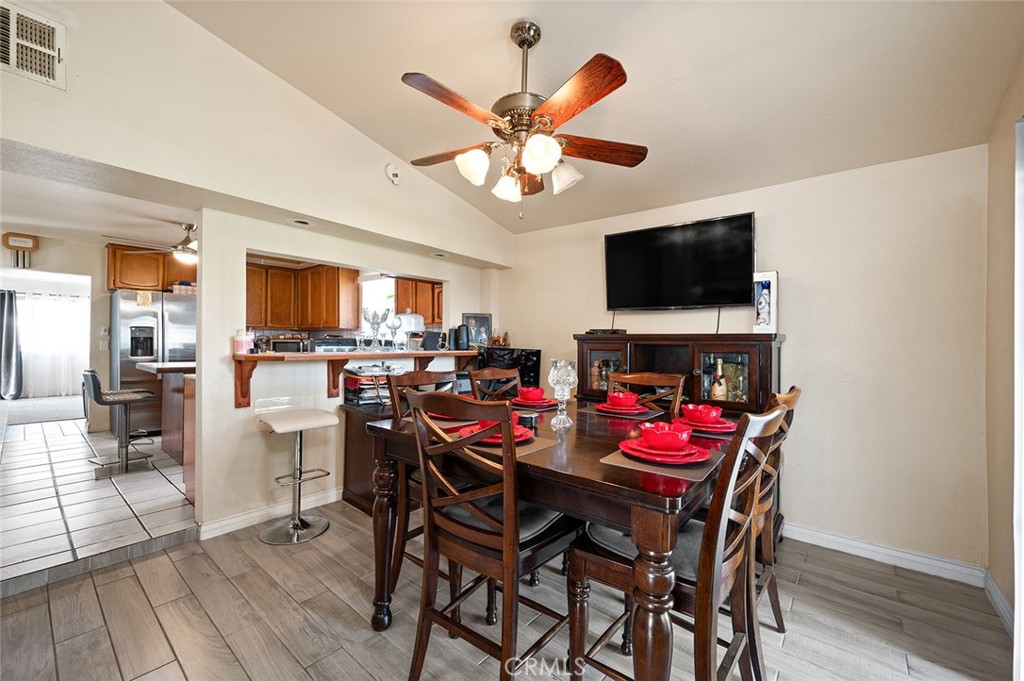 27447 Cypress Street Highland, CA 92346 - Photo 14 of 42 a view of a dining room with furniture and a kitchen