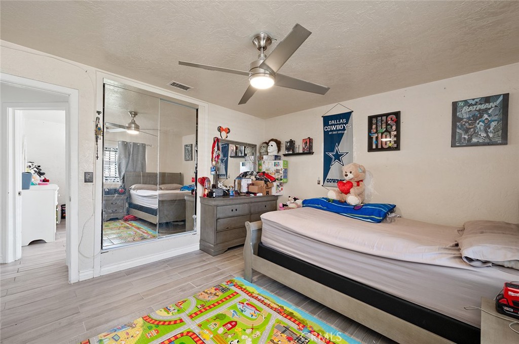 27447 Cypress Street Highland, CA 92346 - Photo 17 of 42 a bed room with a bed and furniture