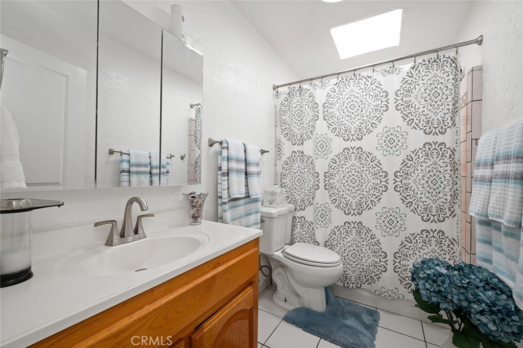 27447 Cypress Street Highland, CA 92346 - Photo 20 of 42 a bathroom with a sink toilet and shower