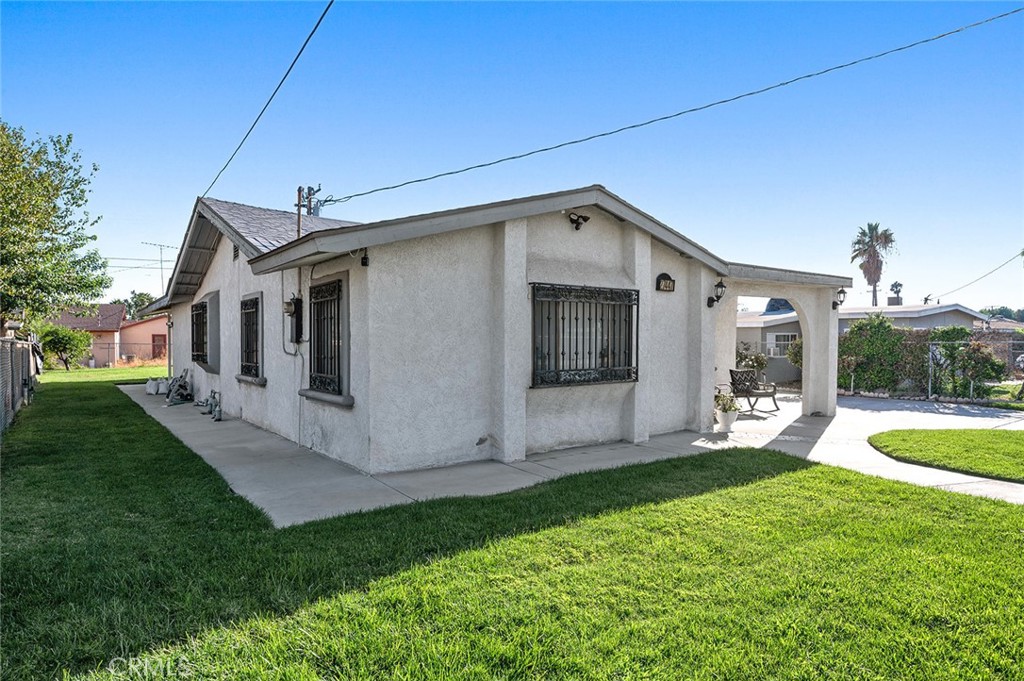 27447 Cypress Street Highland, CA 92346 - Photo 4 of 42 a view of a house with a yard fire pit and a large tree