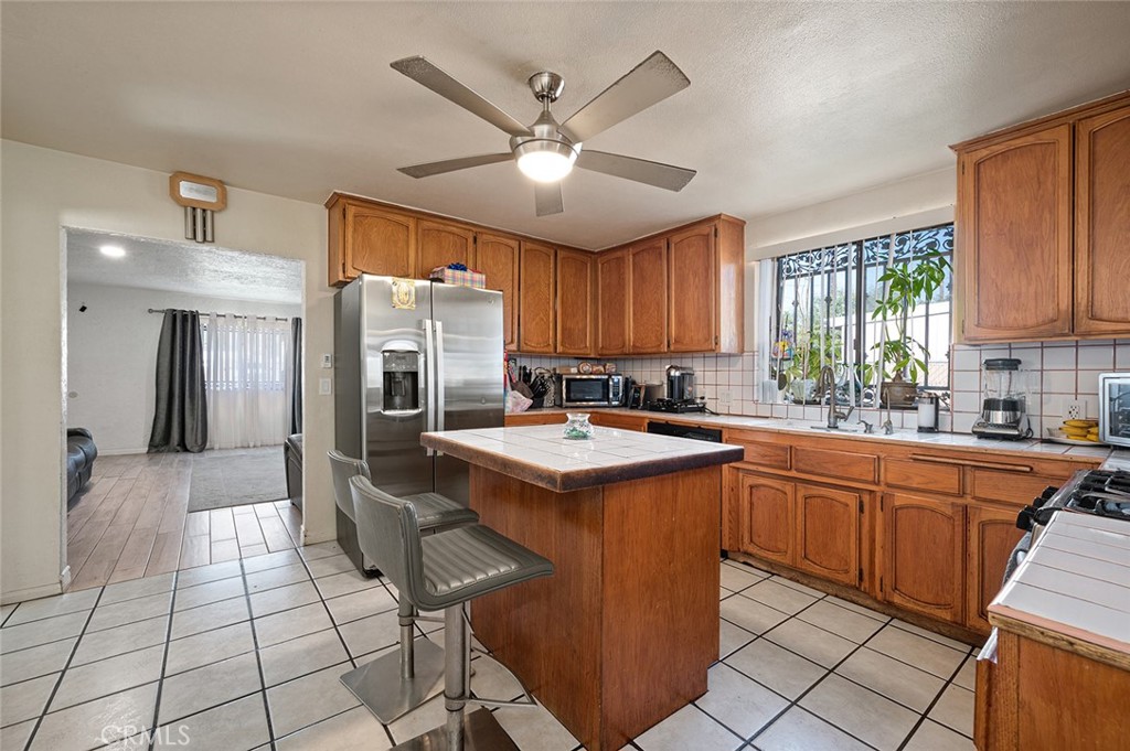 27447 Cypress Street Highland, CA 92346 - Photo 10 of 42 a kitchen with cabinets a sink appliances and a counter top space