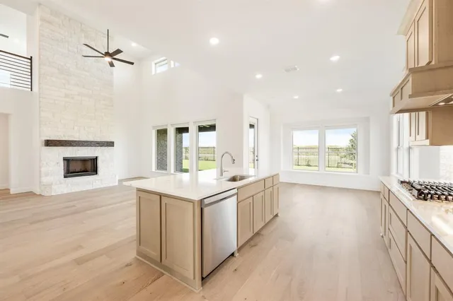 a kitchen with a stove a table and chairs