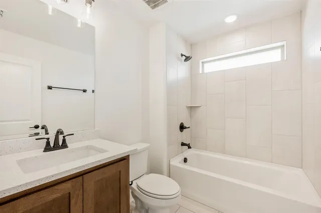 a view of a white house in front of a big yard with large trees