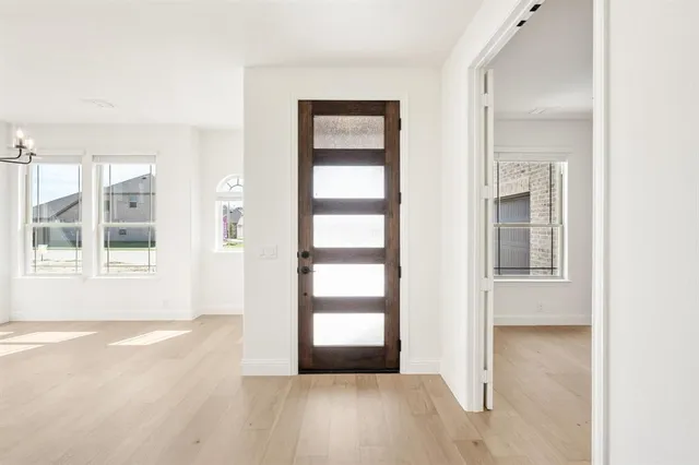 a living room with furniture a table and a large window