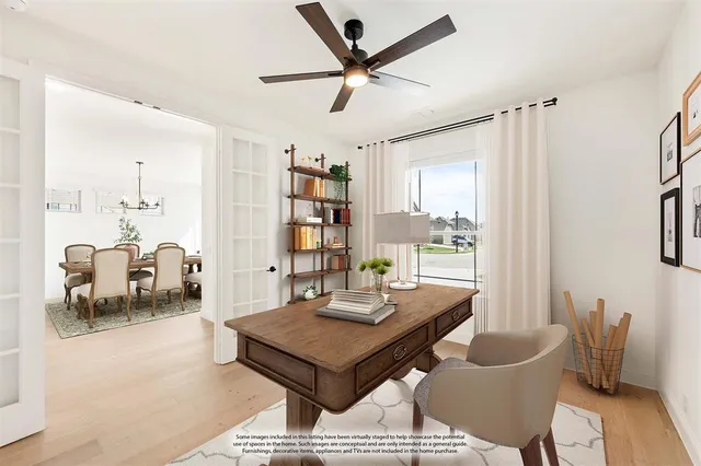 a view of a livingroom with a ceiling fan and wooden floor