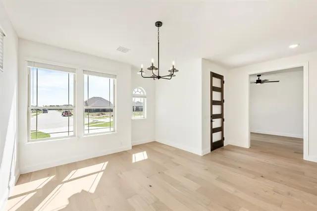 a view of a room with wooden floor staircase and a kitchen